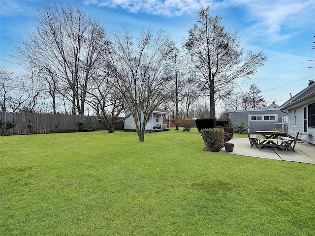 view of yard with a patio, an outdoor structure, and fence