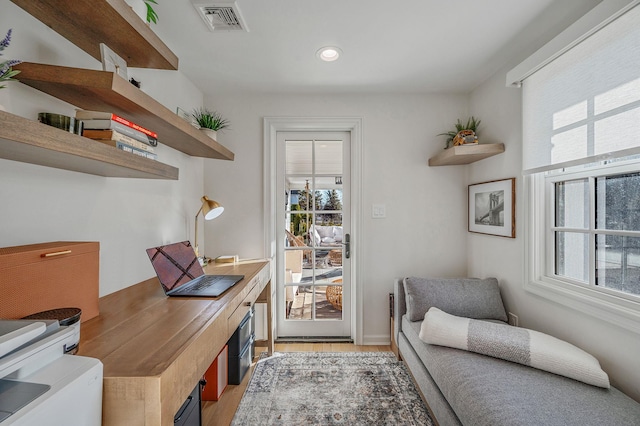 office area featuring light wood finished floors, visible vents, and recessed lighting