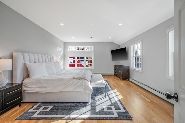 bedroom with light wood-style floors, a baseboard radiator, a baseboard heating unit, and recessed lighting