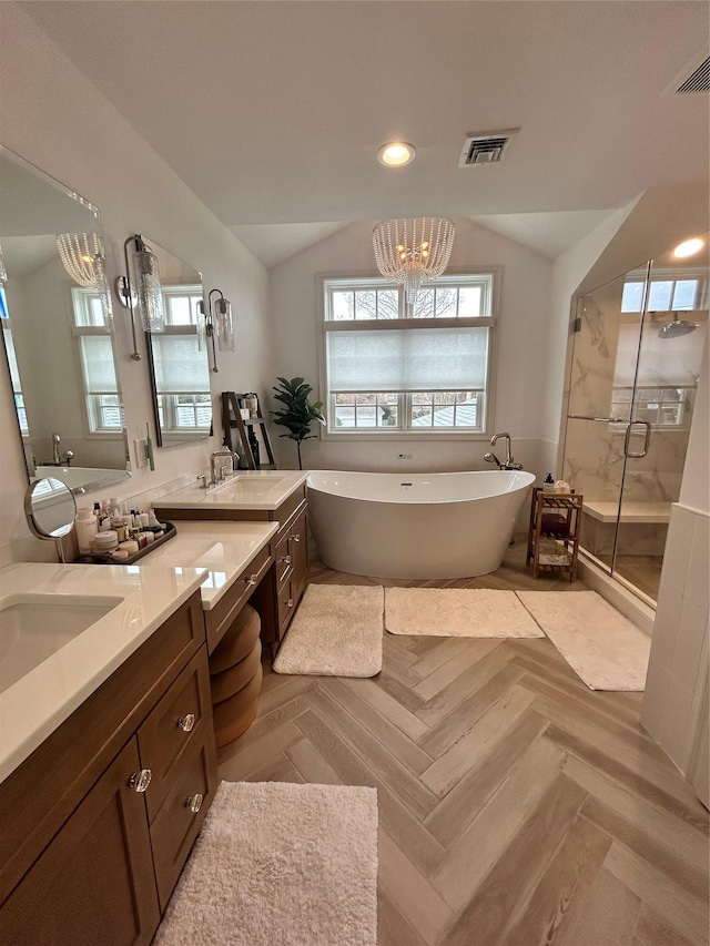 full bathroom with double vanity, a stall shower, visible vents, lofted ceiling, and a freestanding bath