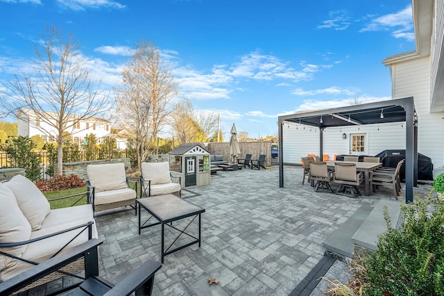 view of patio with grilling area, fence, an outdoor living space, and outdoor dining space