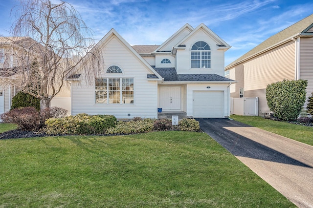 view of front of property featuring driveway, a shingled roof, an attached garage, and a front yard