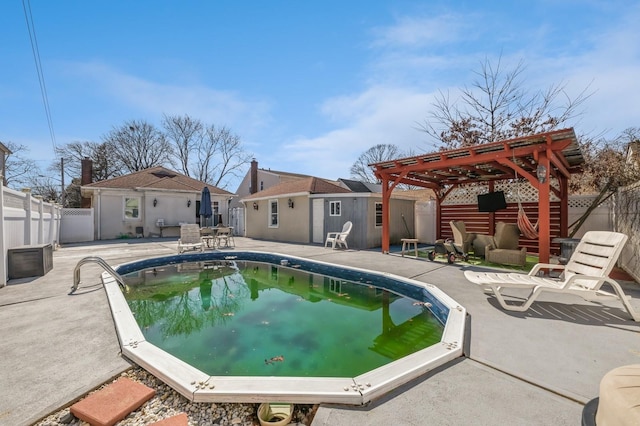 view of pool with a fenced backyard, a patio, a pergola, and an outdoor structure