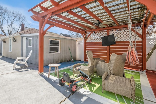 view of patio featuring ceiling fan, an outdoor structure, and a pergola