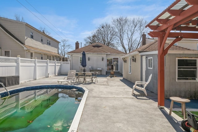 view of swimming pool with a patio area, fence, a fenced in pool, and a pergola