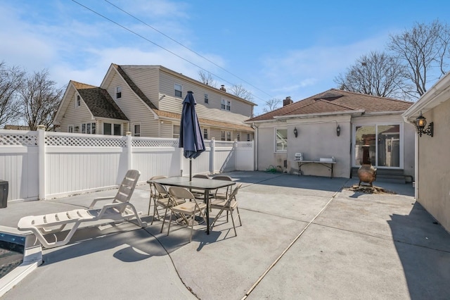 view of patio featuring entry steps, fence private yard, and outdoor dining area