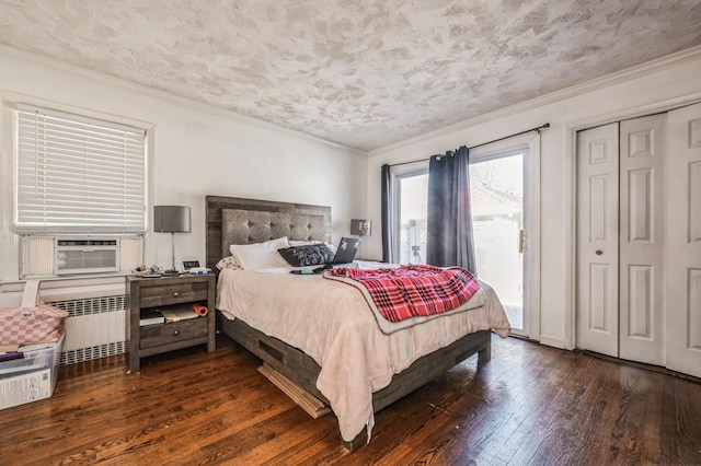 bedroom with hardwood / wood-style flooring, radiator heating unit, cooling unit, and crown molding