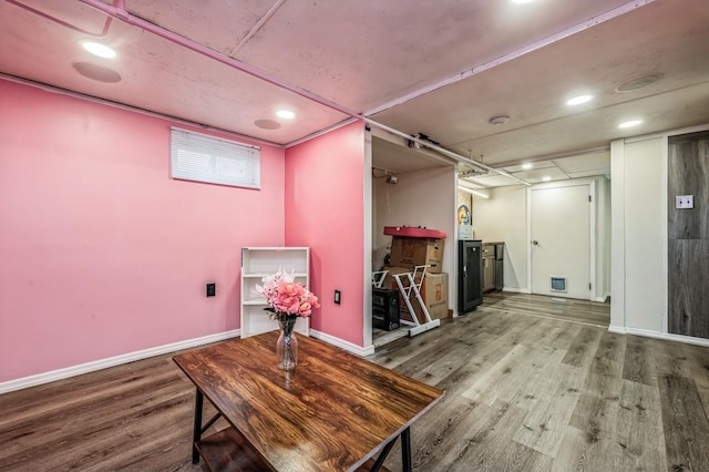 interior space featuring recessed lighting, baseboards, and wood finished floors