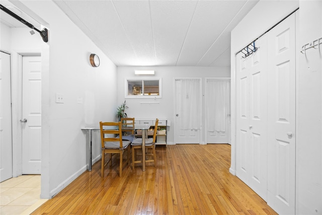 dining area with baseboards and light wood-style floors