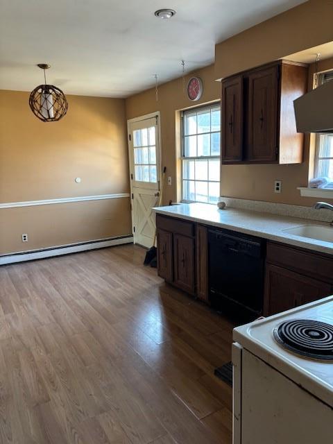 kitchen with electric range, dishwasher, wood finished floors, light countertops, and a sink