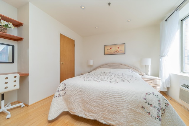 bedroom featuring multiple windows, light wood-style flooring, and recessed lighting