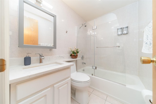 bathroom with enclosed tub / shower combo, vanity, toilet, and tile patterned floors