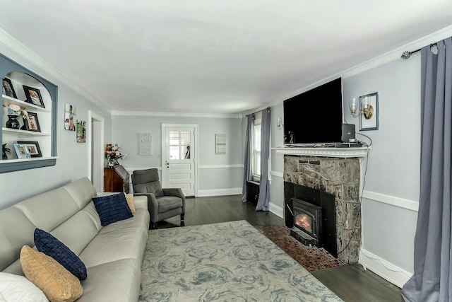 living room with baseboards, ornamental molding, and dark wood-style flooring