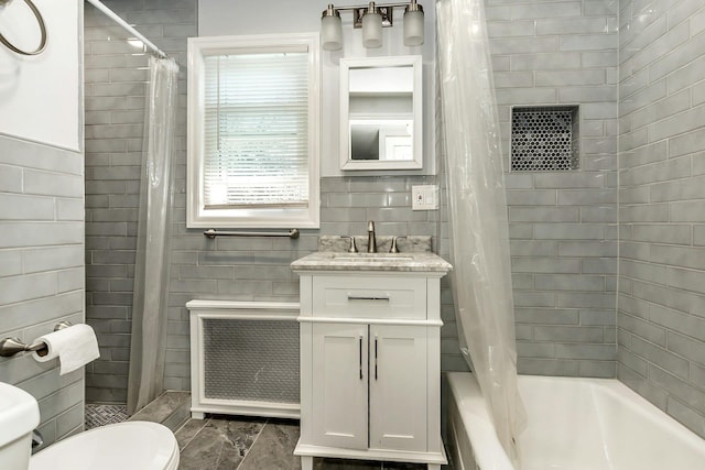 full bath with shower / bath combination with curtain, toilet, tile walls, and vanity