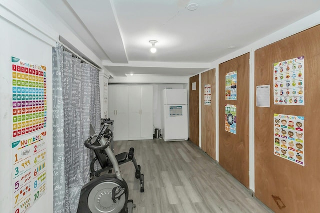 workout area featuring light wood-style floors