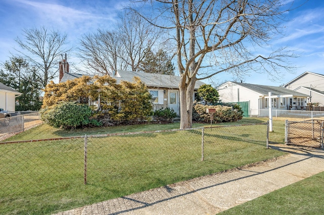 view of front facade with a front lawn, a fenced front yard, and a gate