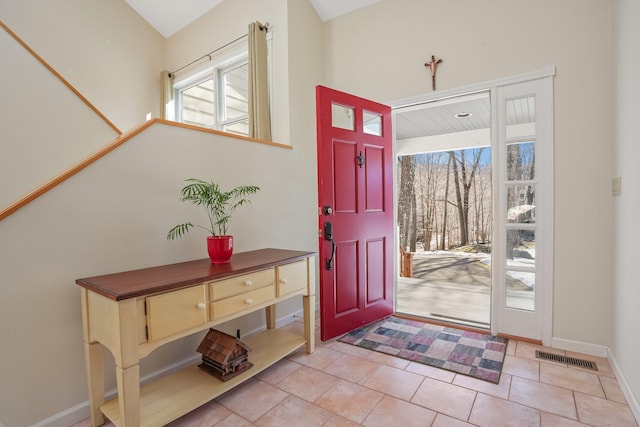 foyer entrance with tile patterned flooring, visible vents, and baseboards