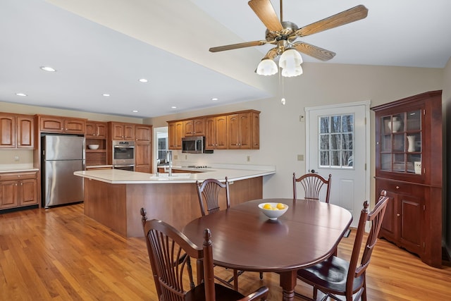 dining room with lofted ceiling, ceiling fan, light wood finished floors, and recessed lighting