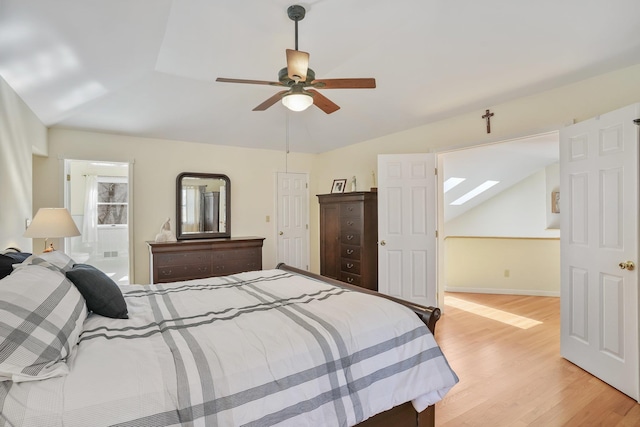 bedroom with lofted ceiling, light wood-style flooring, baseboards, and a ceiling fan