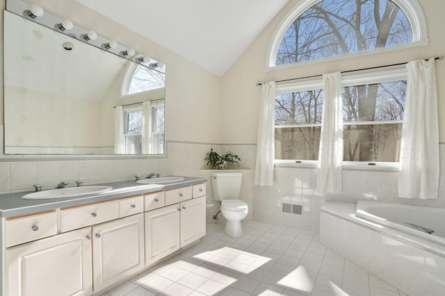 full bathroom featuring toilet, tile patterned flooring, visible vents, and a sink