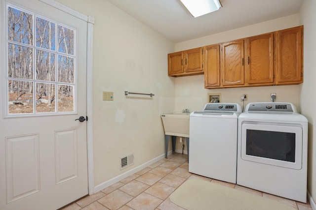 washroom featuring light tile patterned floors, cabinet space, visible vents, independent washer and dryer, and baseboards