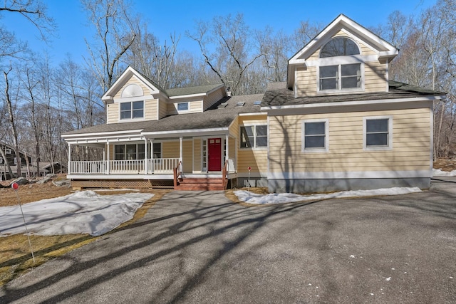 view of front facade featuring a porch and a shingled roof