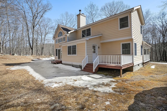 rear view of property with a chimney