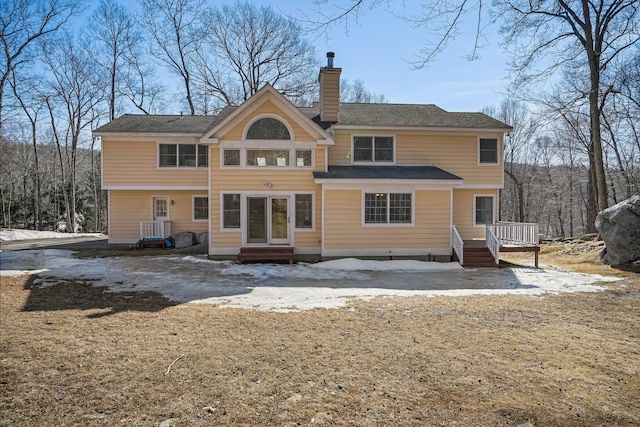 rear view of property with a chimney