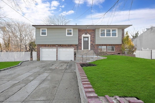 raised ranch featuring brick siding, driveway, a front lawn, and fence