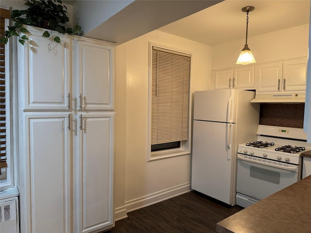 kitchen with under cabinet range hood, white appliances, dark wood-type flooring, baseboards, and white cabinets