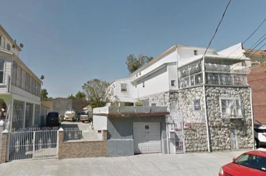 exterior space with a fenced front yard, a gate, and a garage