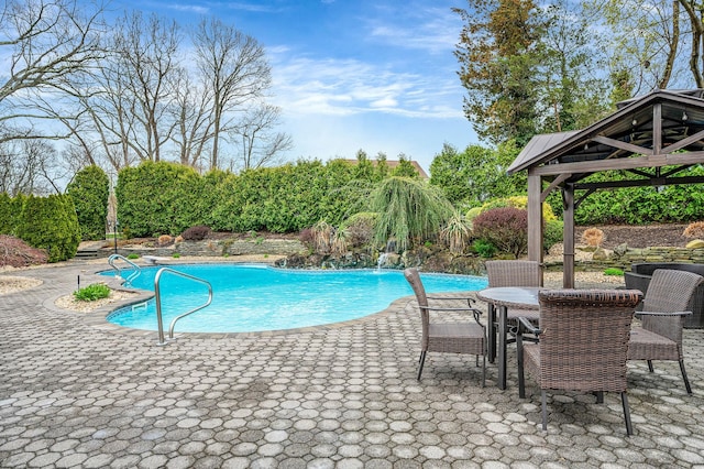 outdoor pool with a patio and a gazebo