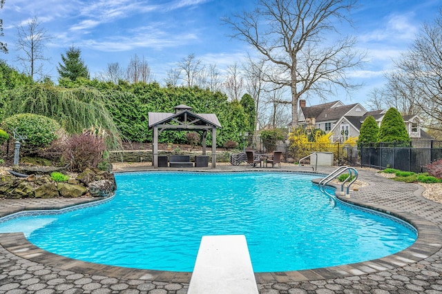 view of pool featuring a diving board, a patio, fence, a gazebo, and a fenced in pool
