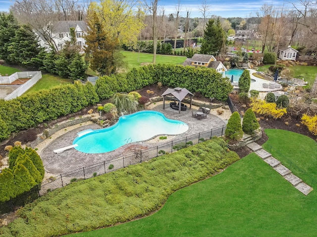 view of pool featuring a lawn, a patio, fence, a gazebo, and a fenced in pool