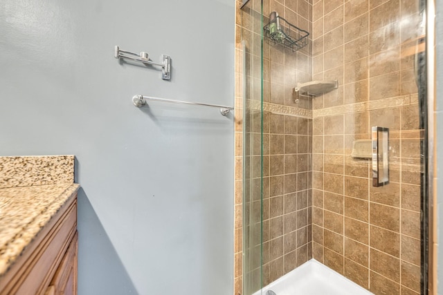 bathroom featuring a stall shower and vanity