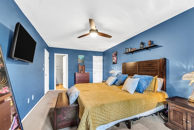 carpeted bedroom with ceiling fan and baseboards