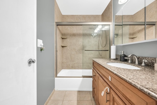 bathroom with shower / bath combination with glass door, vanity, baseboards, and tile patterned floors