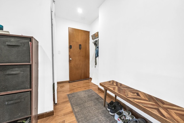 doorway featuring light wood-type flooring and baseboards