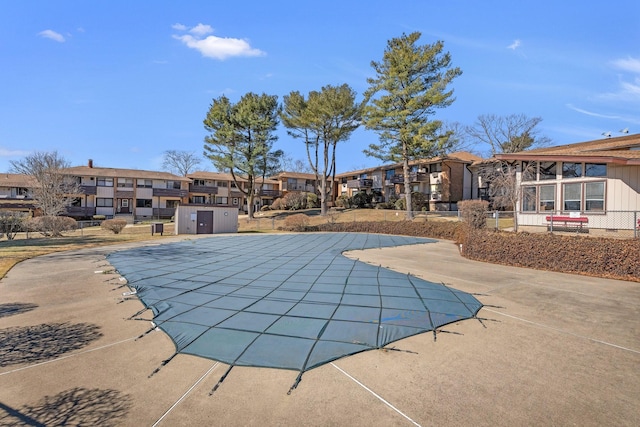 pool featuring a patio and a residential view