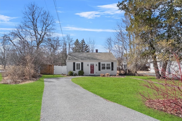 view of front of home with a gate, a front yard, driveway, and fence