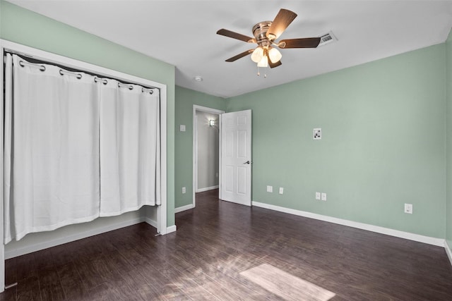 unfurnished bedroom featuring visible vents, ceiling fan, baseboards, and wood finished floors