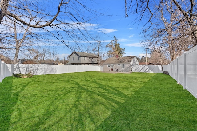 view of yard with a fenced backyard