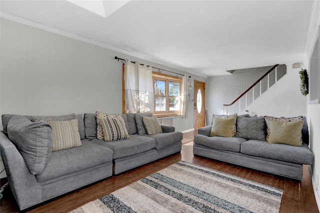 living area featuring stairway, wood finished floors, and crown molding