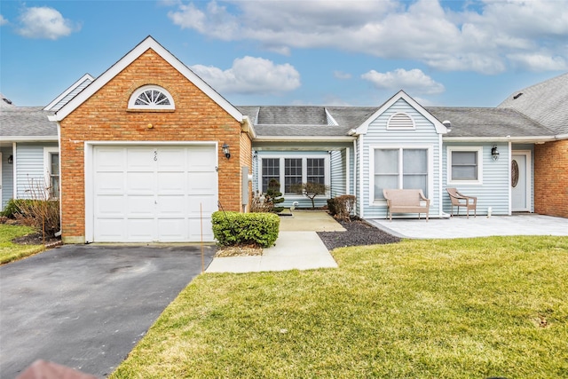 view of front of house featuring aphalt driveway, brick siding, roof with shingles, a front yard, and a garage