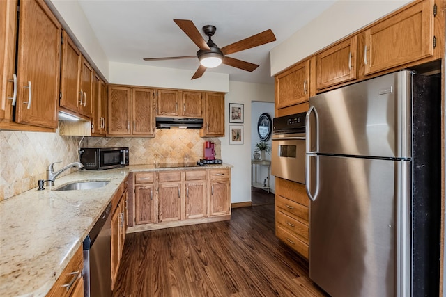 kitchen with dark wood-type flooring, a sink, extractor fan, stainless steel appliances, and backsplash