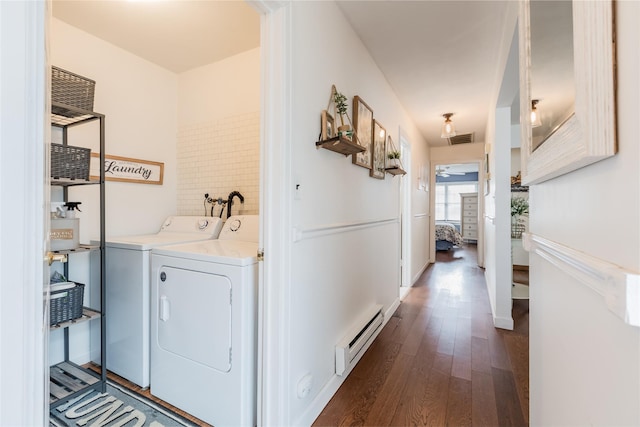 laundry area with a baseboard radiator, washing machine and dryer, laundry area, dark wood-type flooring, and visible vents