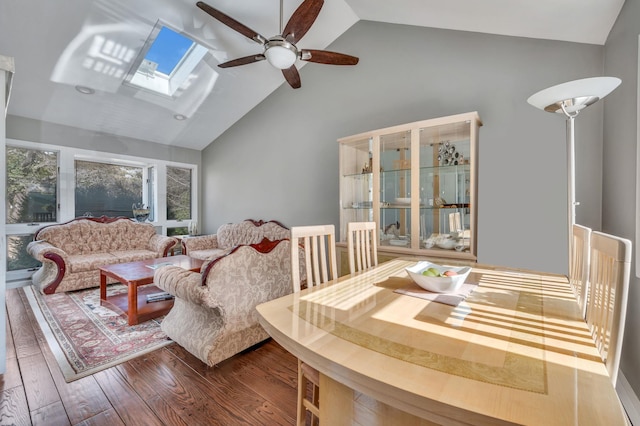 interior space with high vaulted ceiling, a skylight, a ceiling fan, and wood finished floors