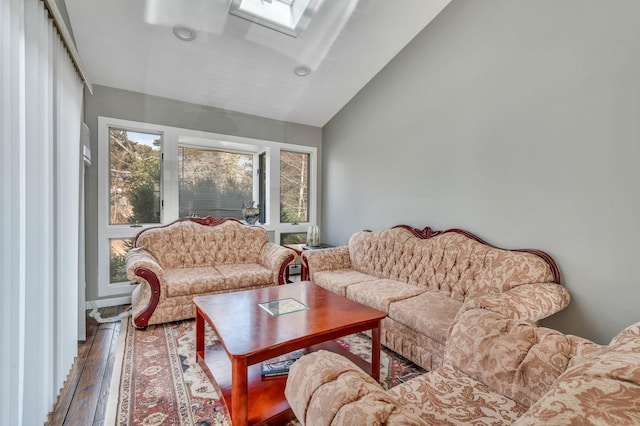 sunroom / solarium featuring vaulted ceiling with skylight