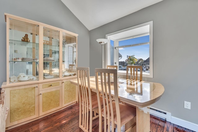 dining room with dark wood-type flooring, lofted ceiling, baseboards, and a baseboard radiator