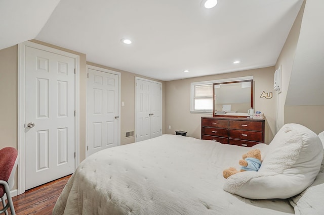 bedroom with recessed lighting, visible vents, and dark wood finished floors